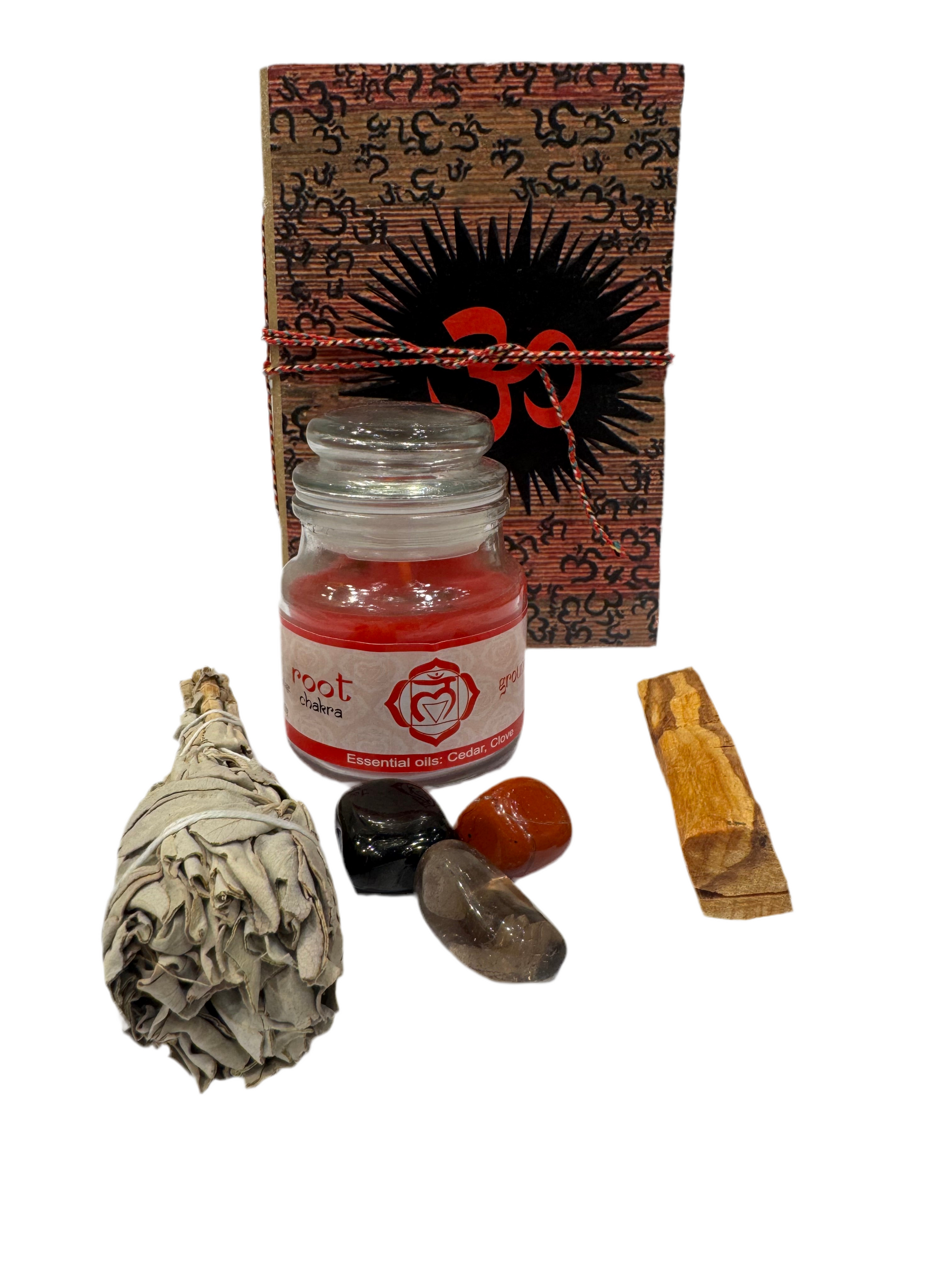 Set of spiritual items including a candle, crystals, and a smudge stick on a white background.