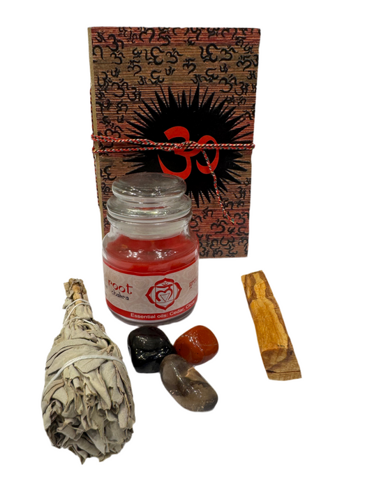 Set of spiritual items including a bottle, sage, stones, and wooden tool on a white background