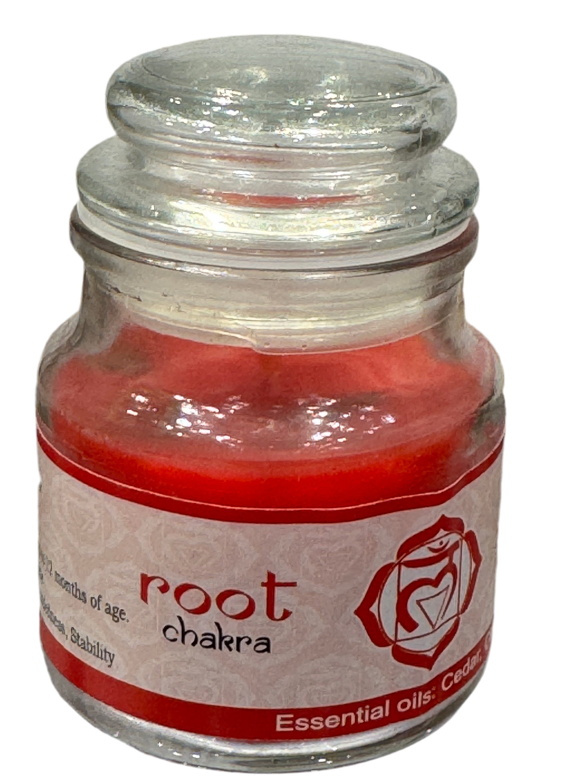 Glass jar with red candle and 'root chakra' label